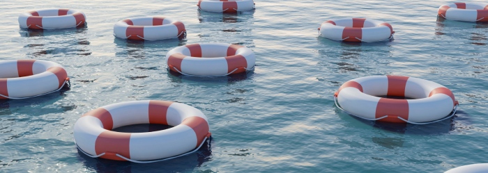 Many life preservers on blue water. High resolution 3D render.